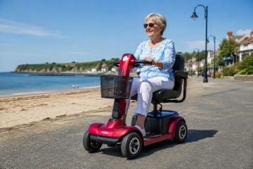 elderly lady out and about on her mobility scooter enjoying the summer weather